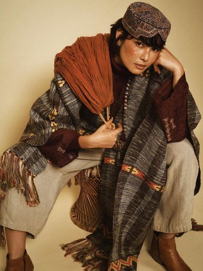 A styled portrait for House of Wandering Silk, layering different textiles and patterns to create a rich, bohemian look.