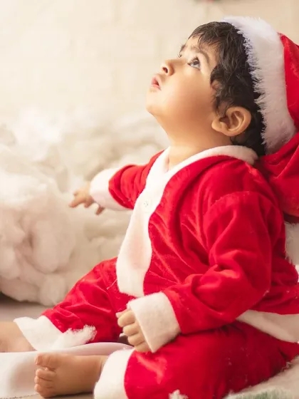 This little one is looking up at the Christmas magic. I use lighting to create a warm, wondrous glow in my holiday photos.