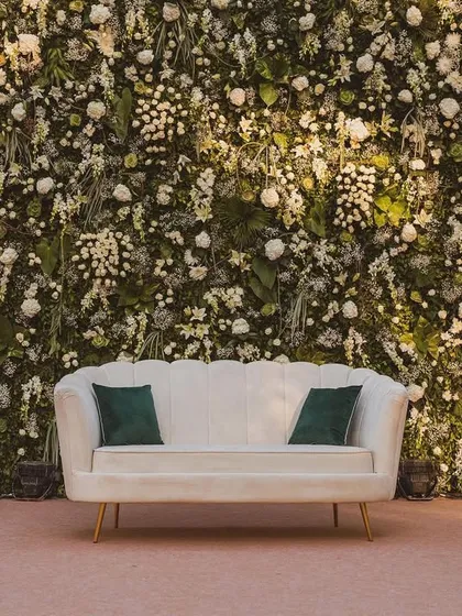 The same floral wall as seen in the previous image, but with slightly different lighting, showcasing its versatility. This simple yet elegant backdrop is perfect for both day and evening events.