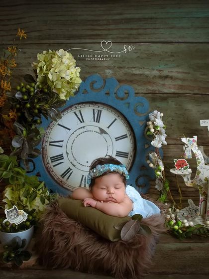 Down the rabbit hole with our very own Alice in Wonderland. This whimsical setup features a vintage clock and storybook elements to create a truly enchanting scene.