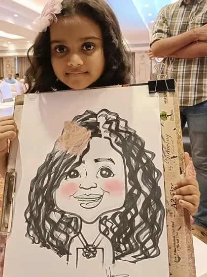 A young girl with curly hair and a flower, very happy with her portrait. Capturing these details is what makes each drawing special.