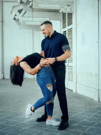 A spontaneous dance in a beautiful architectural setting. This photo captures the fun and chemistry of the couple during their urban pre-wedding shoot.