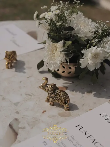 The little details matter. Tiny golden elephant figurines were used as paperweights for the fun-fact cards placed on each table.