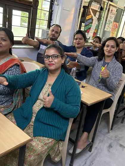 Parents giving a thumbs-up during an activity. Our workshops provide practical tools and insights to help parents support their child's journey effectively.