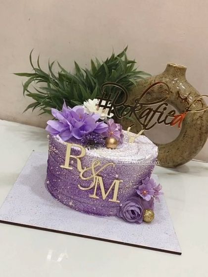 Our purple beauty. This bestselling single-tier design is perfect for a Roka ceremony, covered in purple glitter with a custom hashtag and initial toppers.