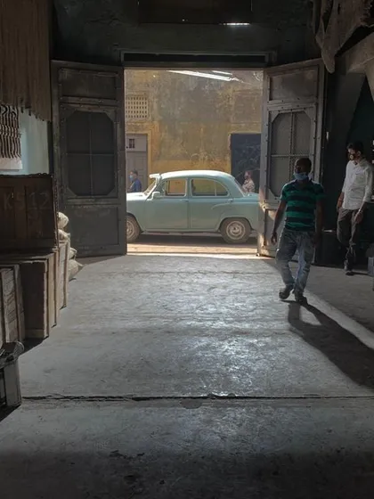 A simple shot of a car outside a doorway, made cinematic through careful lighting. We created a strong, hard backlight to simulate bright exterior sunlight, which contrasts with the softer, ambient light filling the foreground interior space.