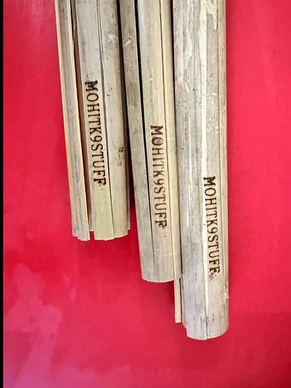 A close-up of my branded "MOHITK9STUFF" bamboo clatter sticks, ready for delivery. These are essential for any trainer looking to add environmental stressors to their protection work.