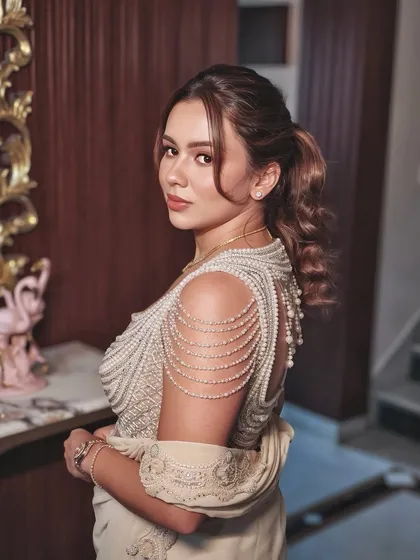 A stunning over-the-shoulder shot revealing the beautiful pearl detailing on the back of the blouse.