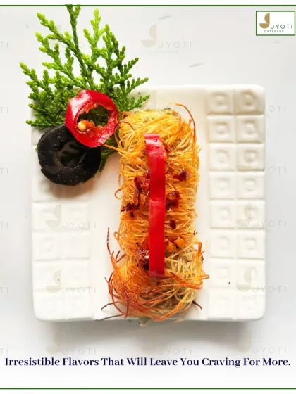 An irresistible appetizer featuring crispy kataifi pastry. The intricate presentation with fresh garnishes promises a bite that is as delicious as it is beautiful.