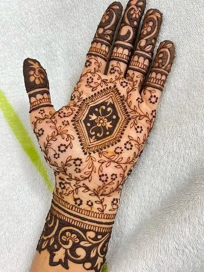 Another shot of the full party henna design, highlighting the contrast between the dark cuff and the delicate vines.