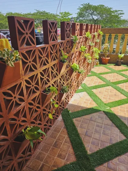 For this gallery space, I designed and installed a custom terracotta jali wall that doubles as a vertical planter. This adds an earthy, traditional touch while creating a unique green feature wall for the balcony.