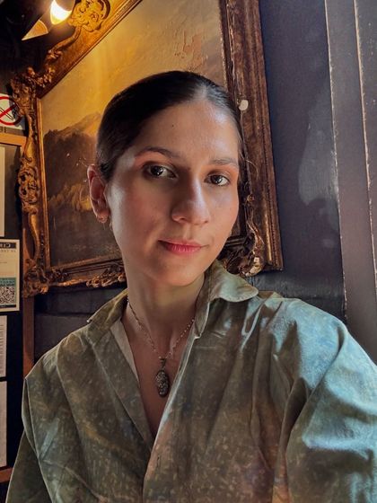 A more subdued look with a sleek bun and a printed green shirt. This shows the quieter, more classic side of my personal style.