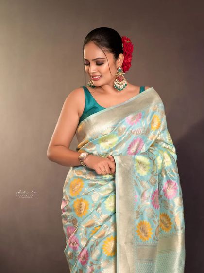 A simple yet elegant portrait in a light blue floral saree. This shows that our studio is also perfect for simpler, more understated traditional looks for any occasion.