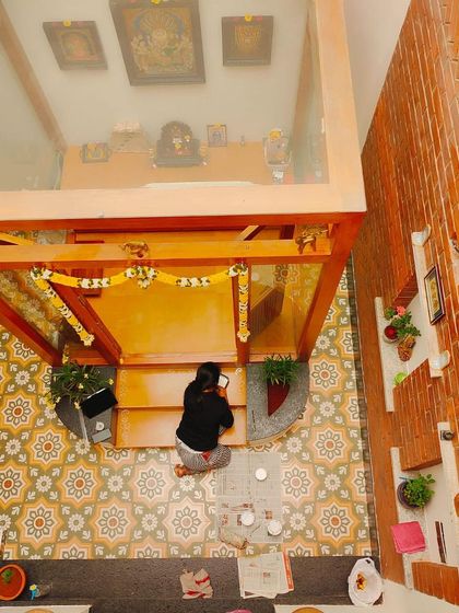 An overhead shot showing the scale of the Alpona project within the home's central courtyard. It demonstrates how architectural art can tie different design elements together.