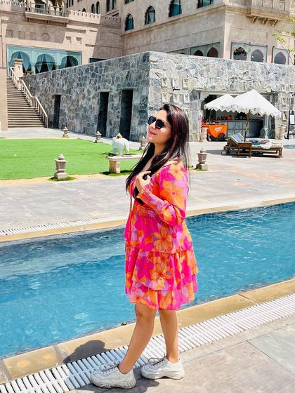 Posing by the pool in Jaipur. This tiered, off-shoulder dress is a great example of a stylish and comfortable vacation outfit.