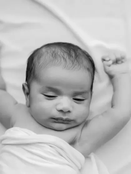 A sleepy stretch captured in timeless black and white. This focuses on the baby's form and delicate features.