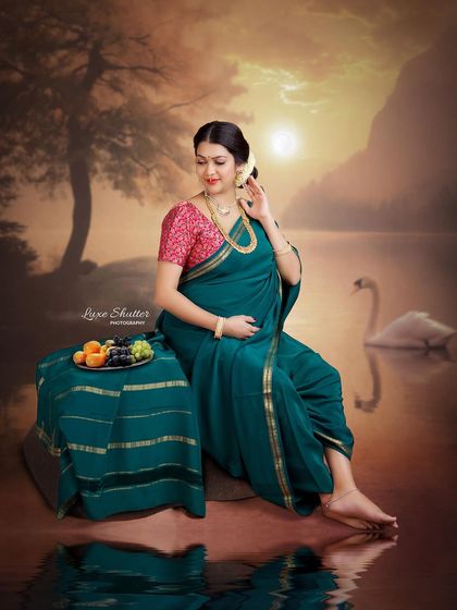 A portrait that speaks of abundance and waiting. The mother-to-be sits with a platter of fruit, a classic symbol in traditional art, set against a beautiful sunset landscape.