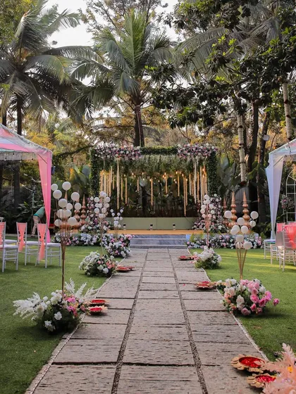 A closer look at a stunning wedding stage. The combination of hanging florals, greenery, and soft lighting creates a romantic and dreamy focal point.