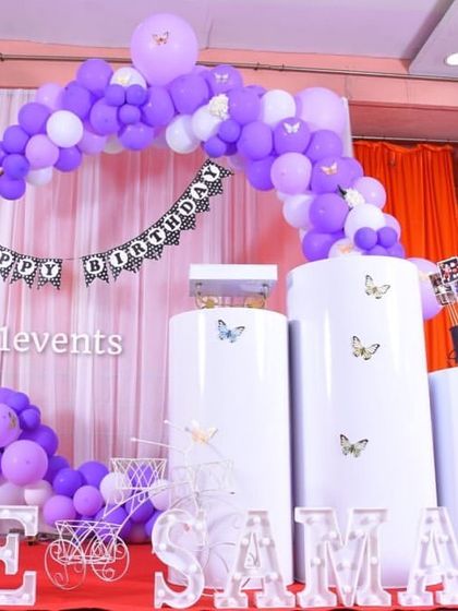 A simple yet elegant purple butterfly theme with a circular arch and marquee letters.