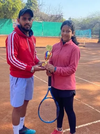 Pakhi Bisht with her coach and trophy after becoming the Runner-Up in the U-14 Doubles at the CS7 tournament in Gurgaon.