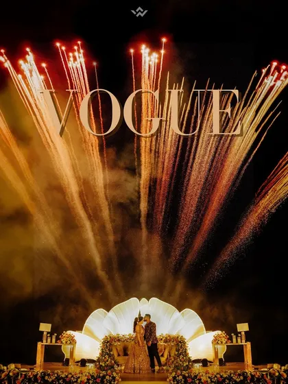 A reception entrance that feels like a movie premiere. With a stunning fireworks display and a grand stage, this shot captures the glamour and excitement of the celebration, making the couple feel like true stars of the night.