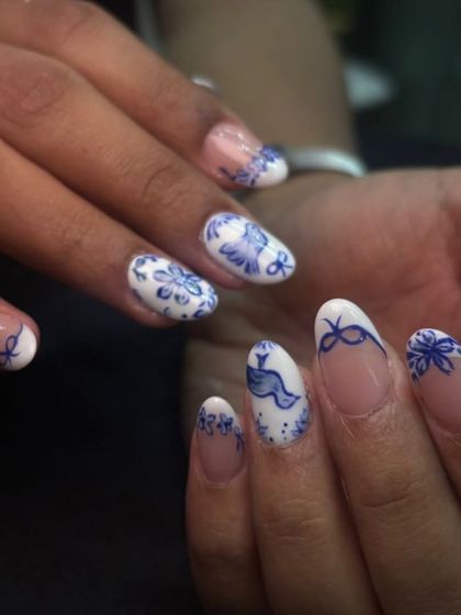 Another angle of the blue and white set, showcasing the different patterns on each nail while maintaining a cohesive, elegant theme.