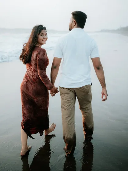 A classic "look back" pose during a beach walk. This shot combines a sense of journey with a personal connection to the camera.