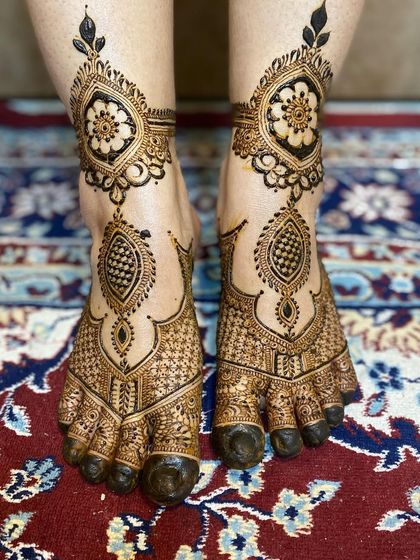 A stunning bridal foot design, with a floral cuff around the ankle and intricate patterns covering the foot.