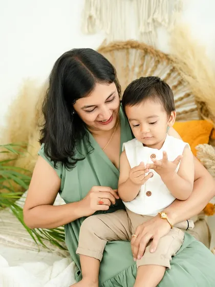 Examining his tiny fingers. These small, everyday interactions are the 'tiny moments' that hold so much love and meaning.