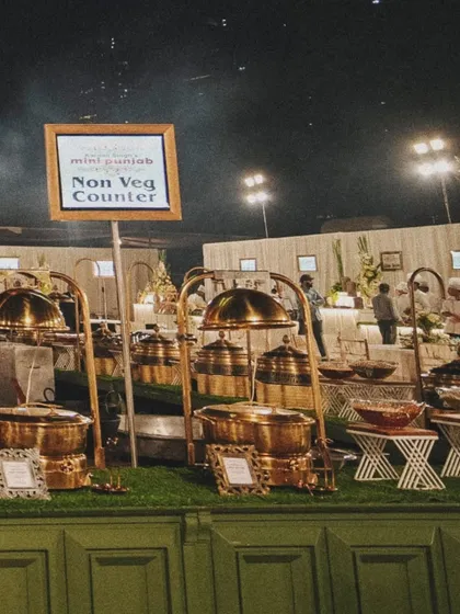 Our non-vegetarian counter, featuring a variety of dishes served in elegant brass-domed chafing dishes.