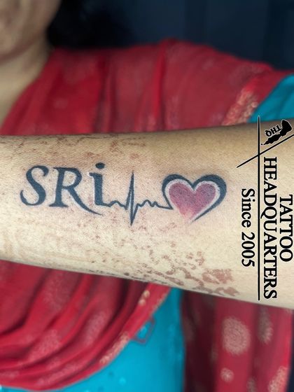 The name "SRI" integrated with a heartbeat line and a red-shaded heart.