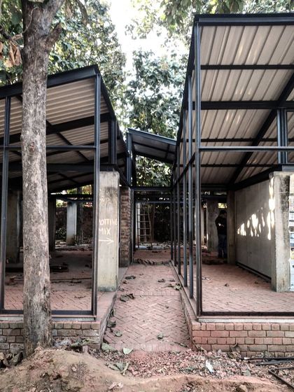 The steel skeleton of the Artist Residency during early construction. This view reveals the logic of the design, with modular frames creating a series of inside-out spaces and corridors that are defined by their relationship to the trees and the ground.