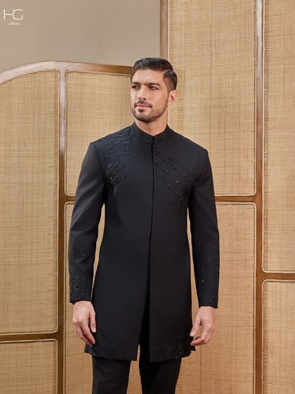 This embroidered Achkan is designed to own the spotlight. The intricate, tonal embroidery on the shoulder and cuffs adds a layer of sophisticated detail without overwhelming the silhouette.
