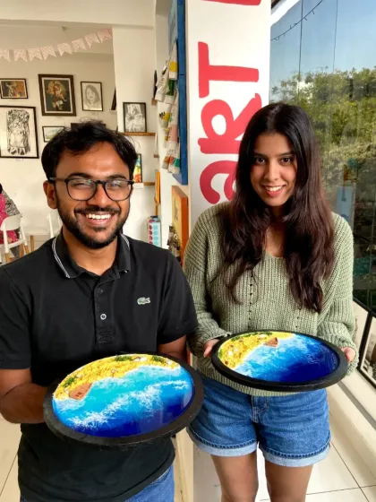 A couple with their finished resin beach art. It's a wonderful way to spend an afternoon and create something beautiful for your home.