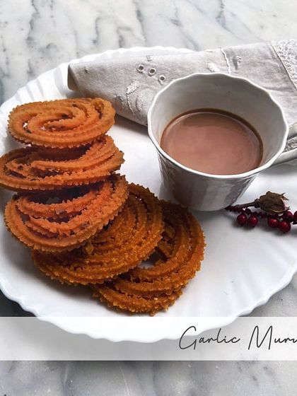 My Garlic Murukku is made with rice flour, besan, garlic, sesame seeds, red chillies, and salt. The garlic adds a wonderful, pungent aroma and taste.