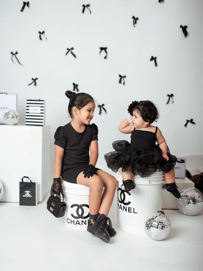 The little sister looks up to her big sister in this adorable themed shot. My studio can be transformed to bring any creative vision to life.