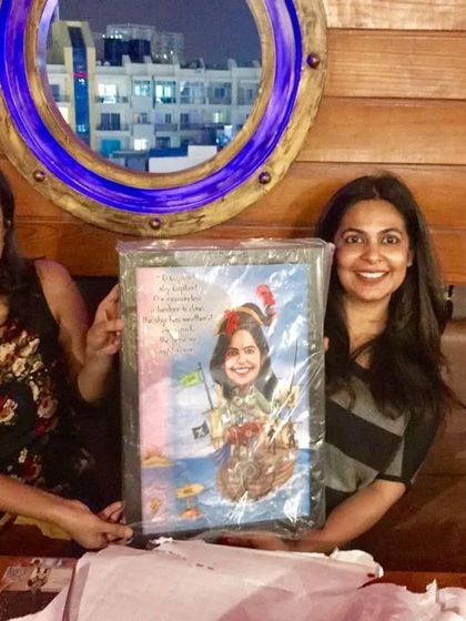 The happy client receiving her custom pirate-themed caricature, a truly unique and personalized gift.