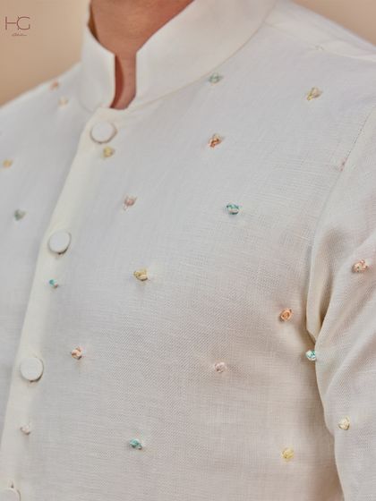 A detail shot of the subtle, multi-colored French knots on this cream bundi, adding a playful yet sophisticated element perfect for daytime festivities.