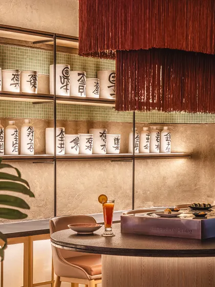 Detail is everything. At the Lucky Chan sushi bar, we layered a cascading tassel light fixture over traditional Japanese scripted pots to create a corner that feels both whimsical and grounded, blending modern aesthetics with cultural authenticity.