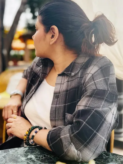 Another candid shot from the cafe, focusing on my relaxed posture and accessories.