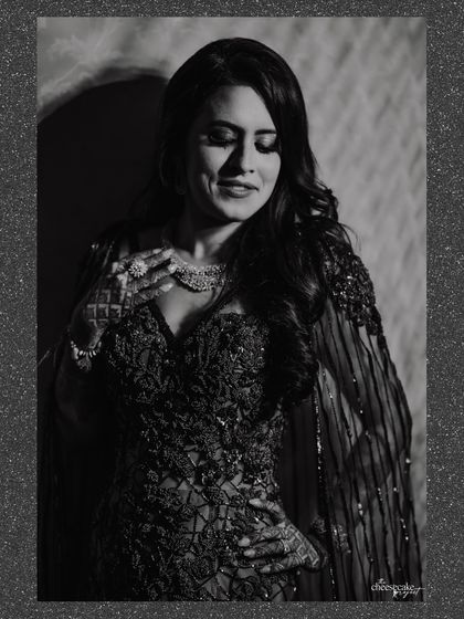 A soft, grainy black and white portrait of the bride, looking elegant and timeless.