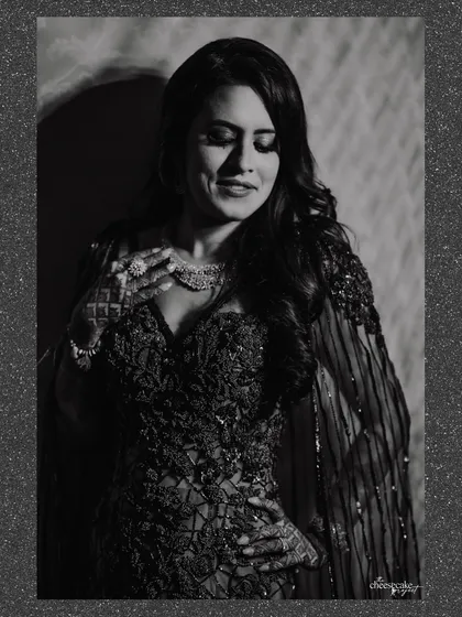 A soft, grainy black and white portrait of the bride, looking elegant and timeless.