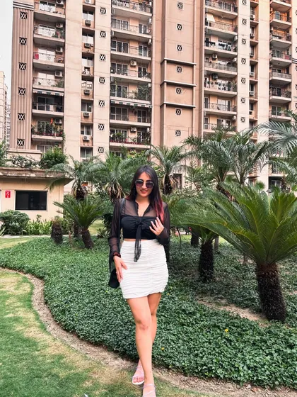A stylish look with a sheer black top and a white ruched skirt from NewMe. This is a great outfit for a brunch or a day out.
