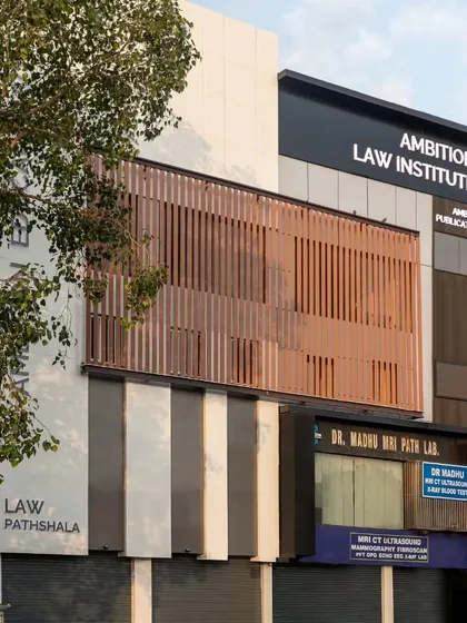 The completed facade of the Ambition Law Institute in Delhi. Our design solution provides a contemporary and professional identity that stands out in its urban context, using a balanced composition of solids, voids, and louvered screens.
