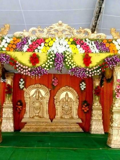 I am experienced in creating traditional mandaps for specific cultural ceremonies. This setup is designed for a South Indian wedding, featuring ornate golden pillars and divine figures.