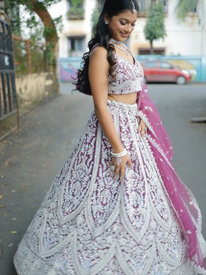 A side view of the wine colored lehenga, showing the beautiful flow of the skirt and the detailed embroidery.