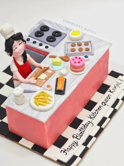 A different angle of the kitchen-themed cake, showing the checkered floor pattern.