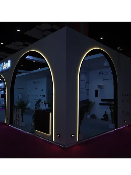 Our exhibition booth illuminated at night. The architectural arches and integrated lighting were designed to create a welcoming and high-tech entrance, inviting visitors to explore the world of TechVault.