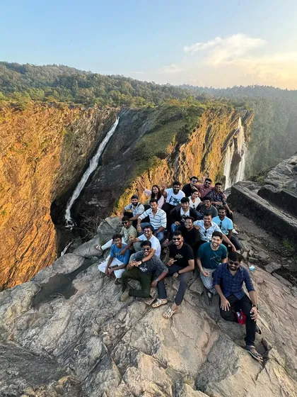 Our group posing on the rocks at the magnificent Jog Falls viewpoint during a Gokarna trip.