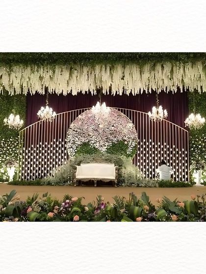 A wider view of the floral reception stage, showcasing the scale and artistry of the design. It’s a perfect example of how we transform a space into a floral haven.